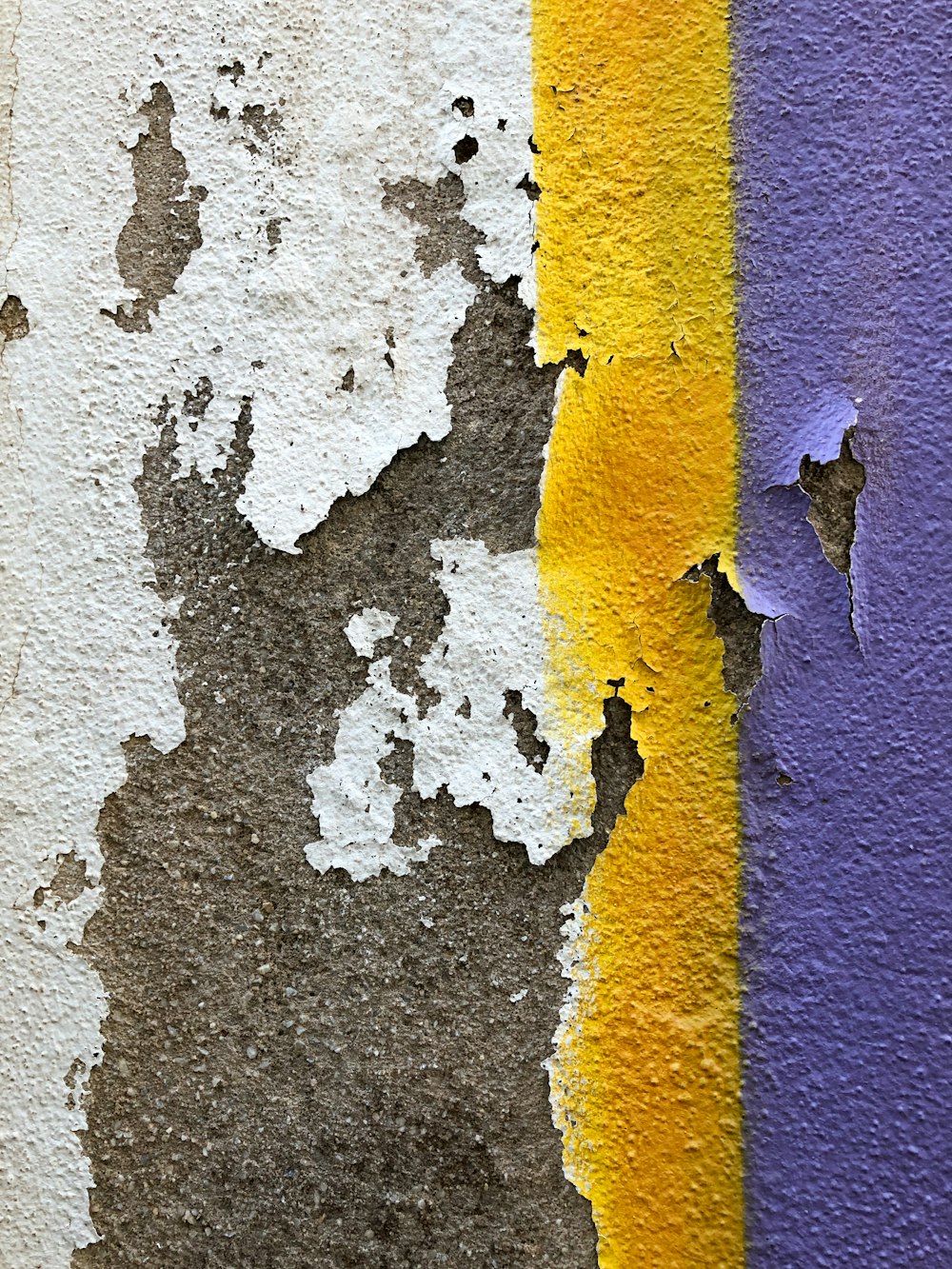 a close up of a wall with peeling paint