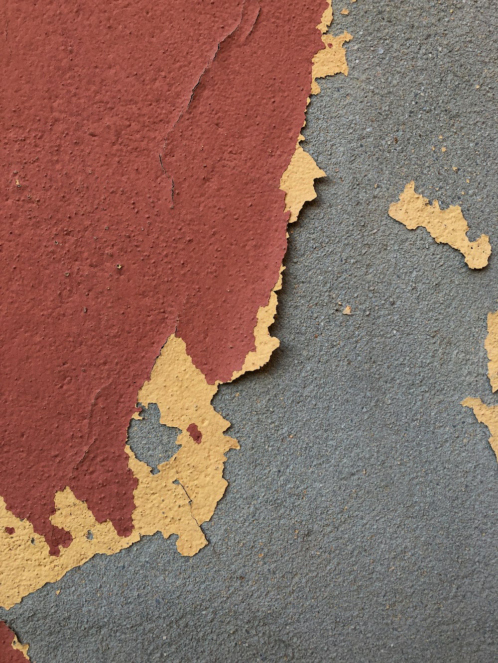 a close up of a wall with peeling paint