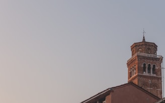 a tall tower with a clock on top of a building