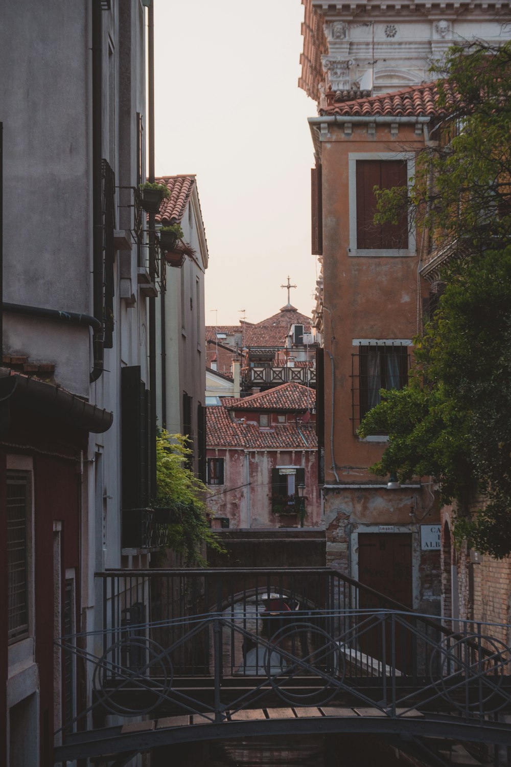 a bridge over a small canal in a city