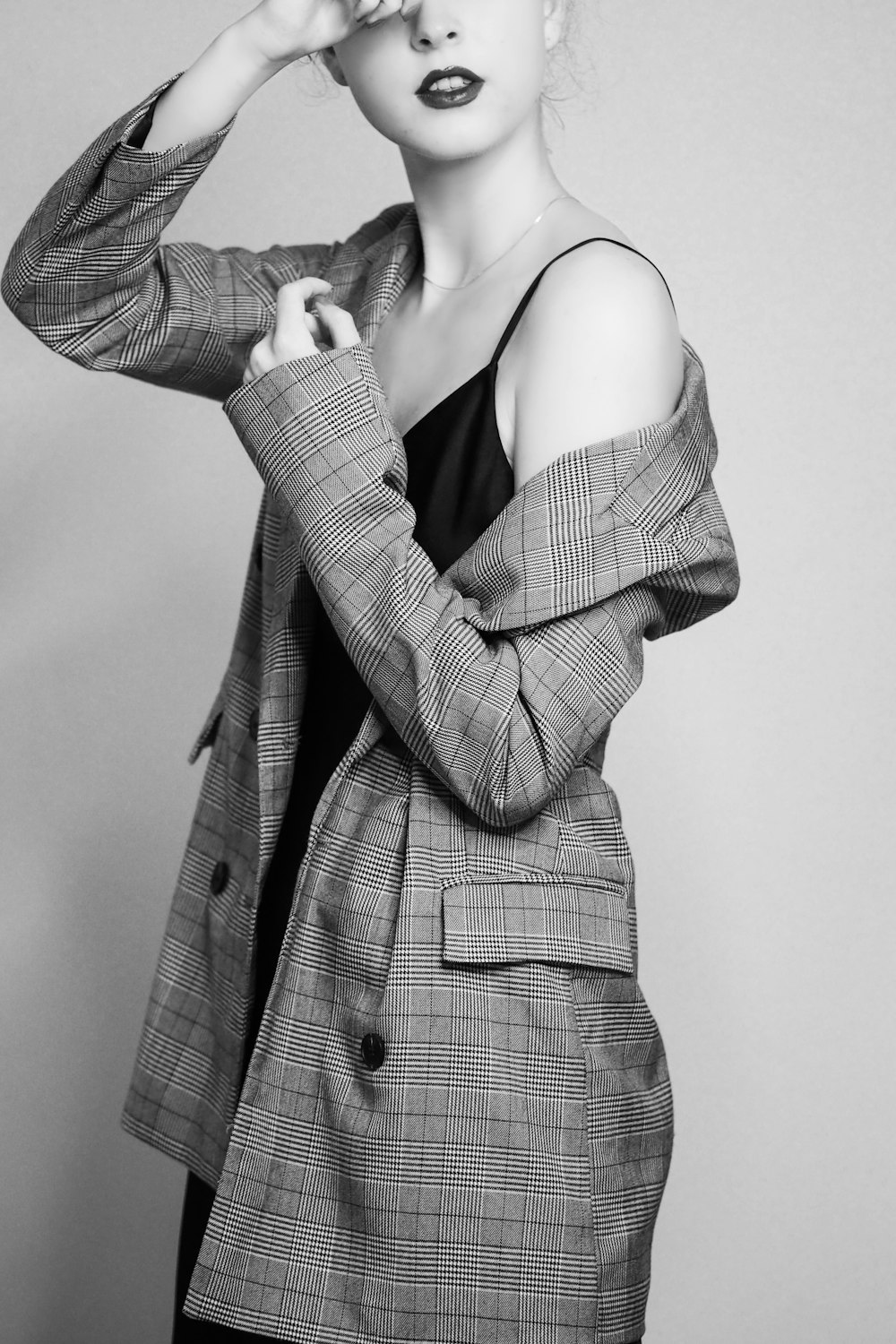 a woman in a blazer poses for a black and white photo