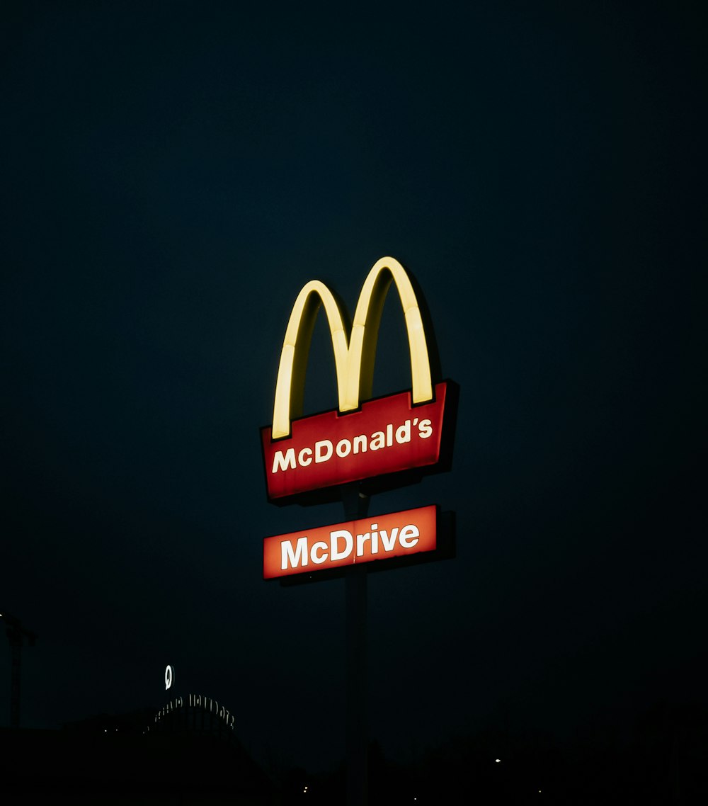 a mcdonald's restaurant sign lit up at night