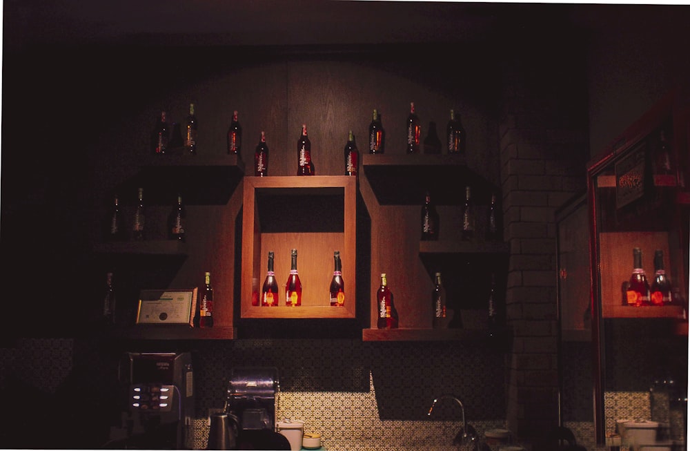 a bunch of bottles that are on a wall