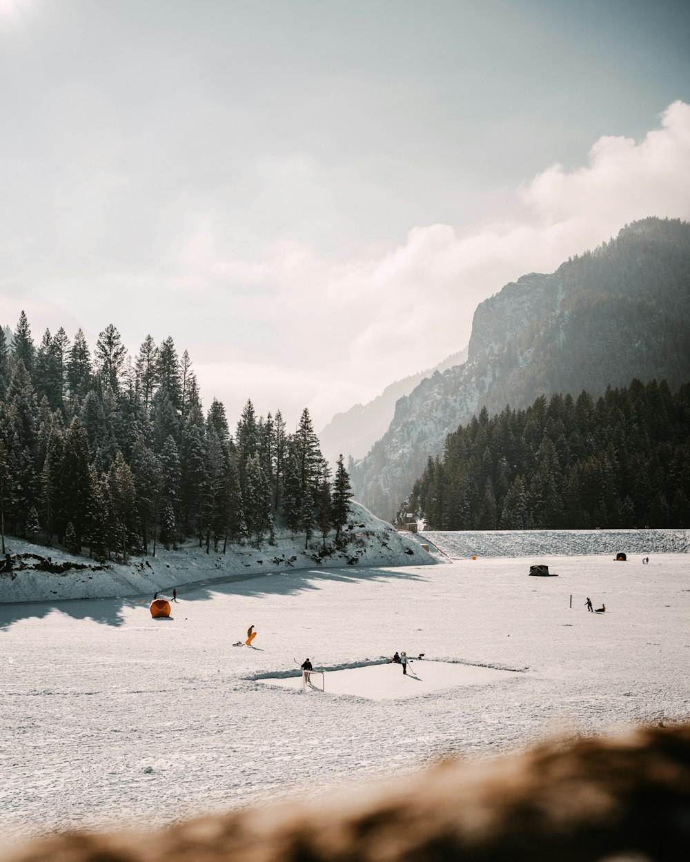 a group of people skiing across a snow covered field