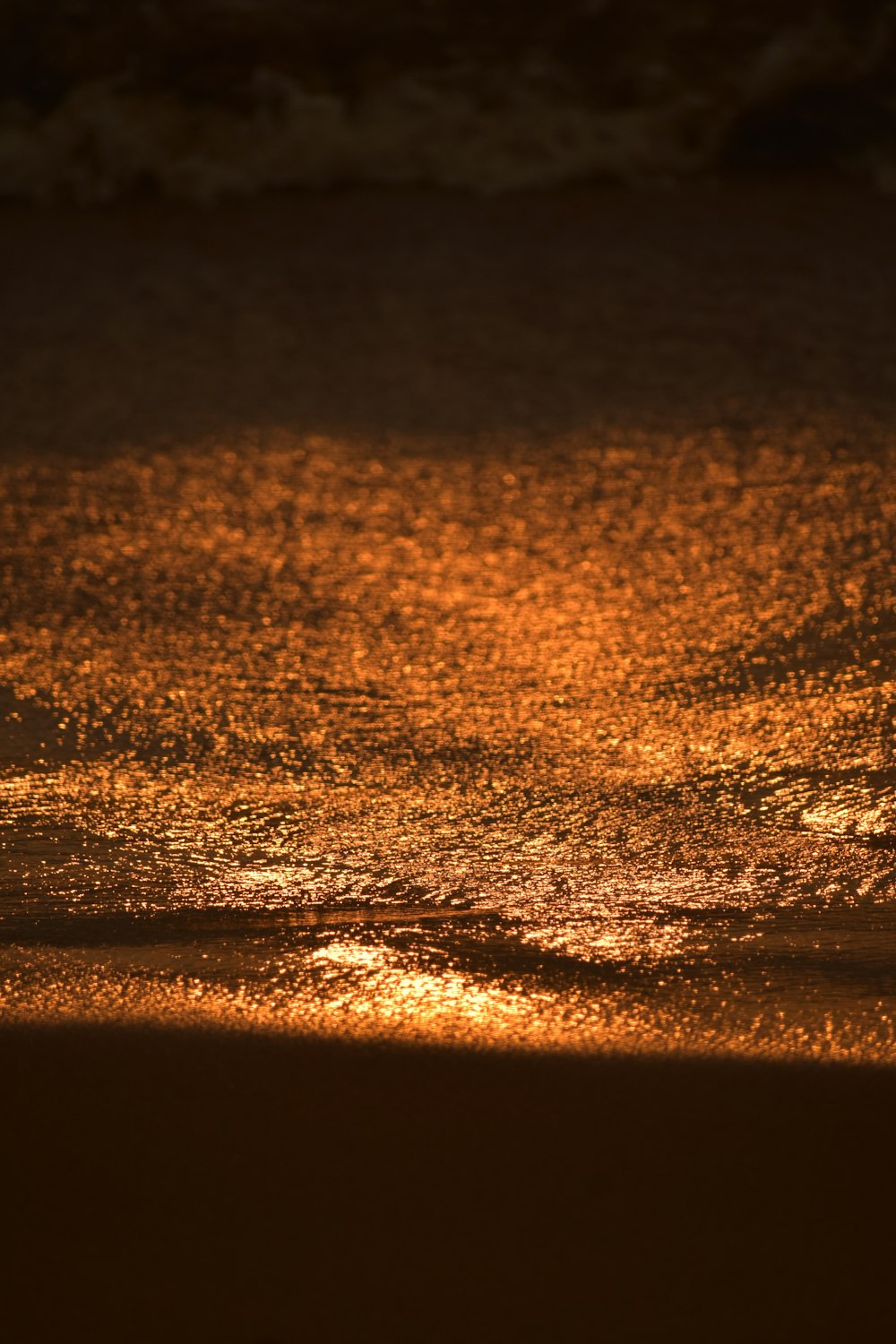 a person walking on the beach at night