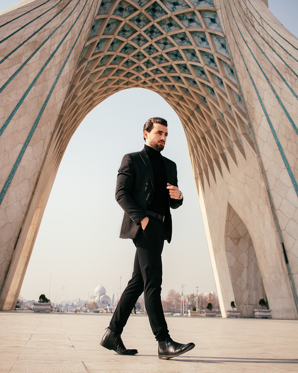 a man in a suit standing in front of a building