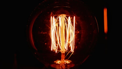 a light bulb is lit up in the dark