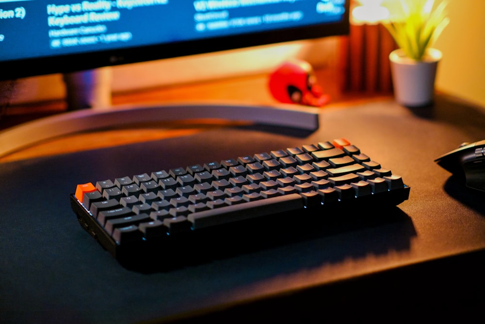 a computer keyboard sitting on top of a desk