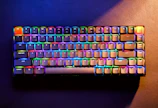 Vibrant mechanical keyboard with RGB backlighting in a dark gaming setup.