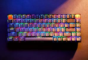 Hands typing on a compact mechanical keyboard with vibrant backlighting