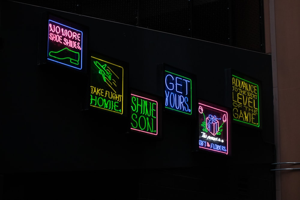 neon signs on the side of a building