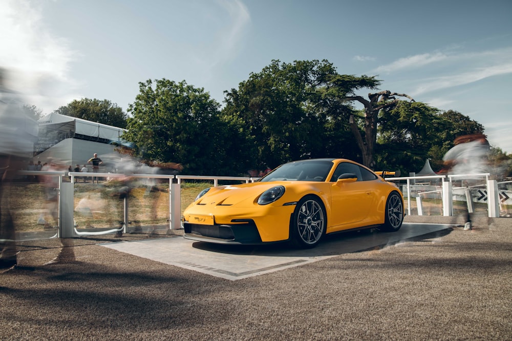 a yellow sports car parked in a parking lot