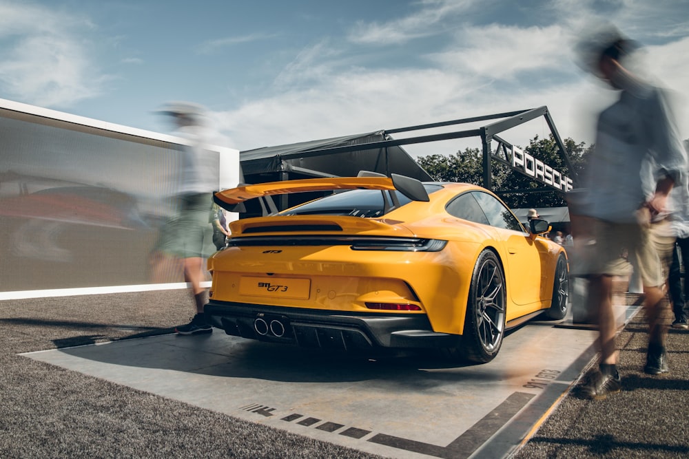 a yellow sports car parked in a parking lot