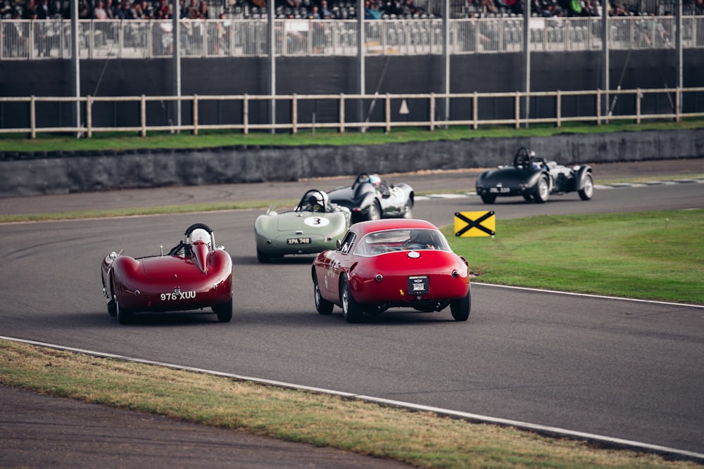 a group of cars driving down a race track