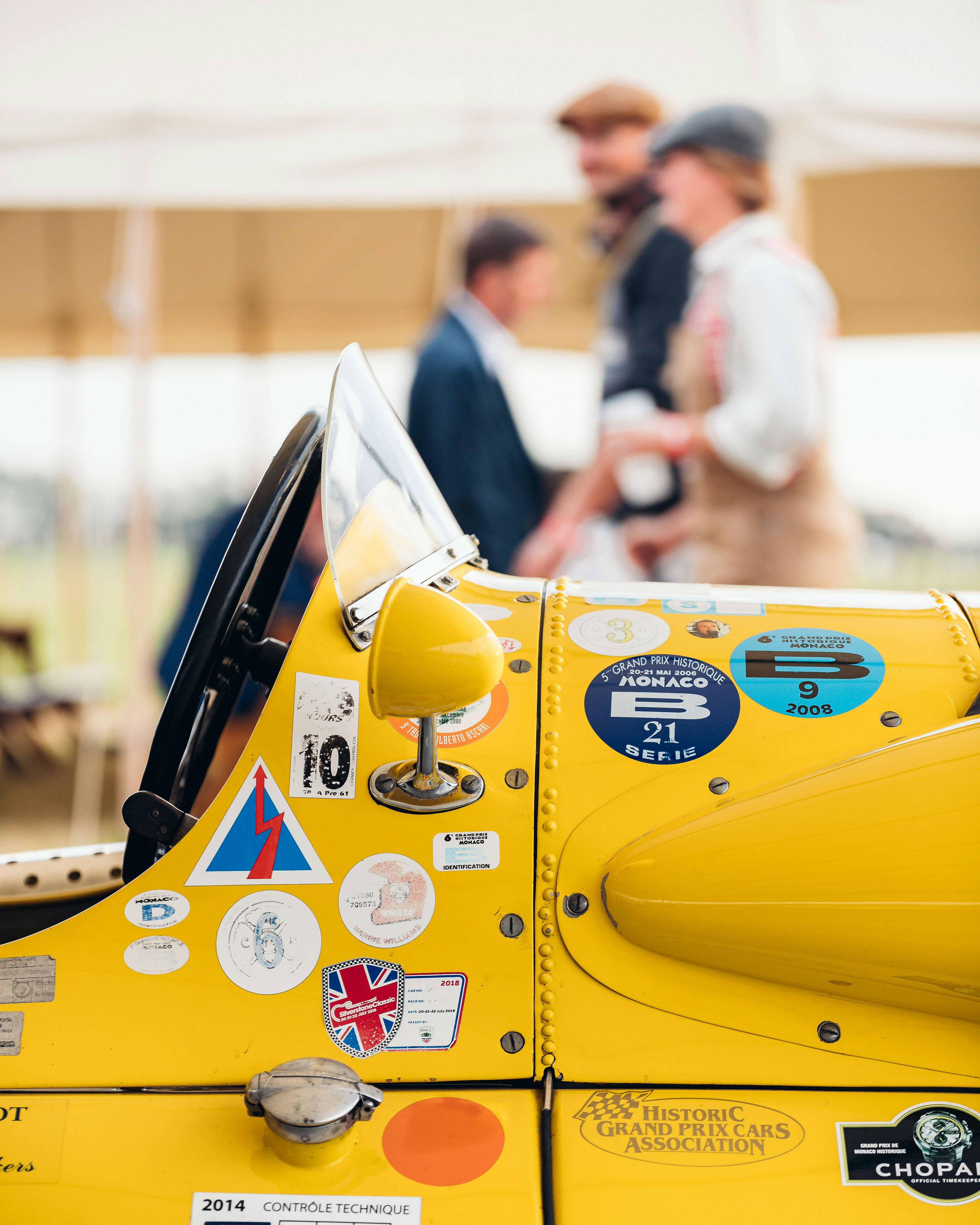 a close up of a yellow vehicle with stickers on it