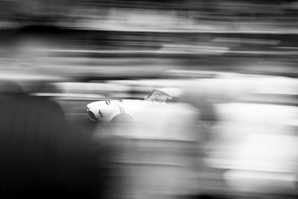 a black and white photo of a race car