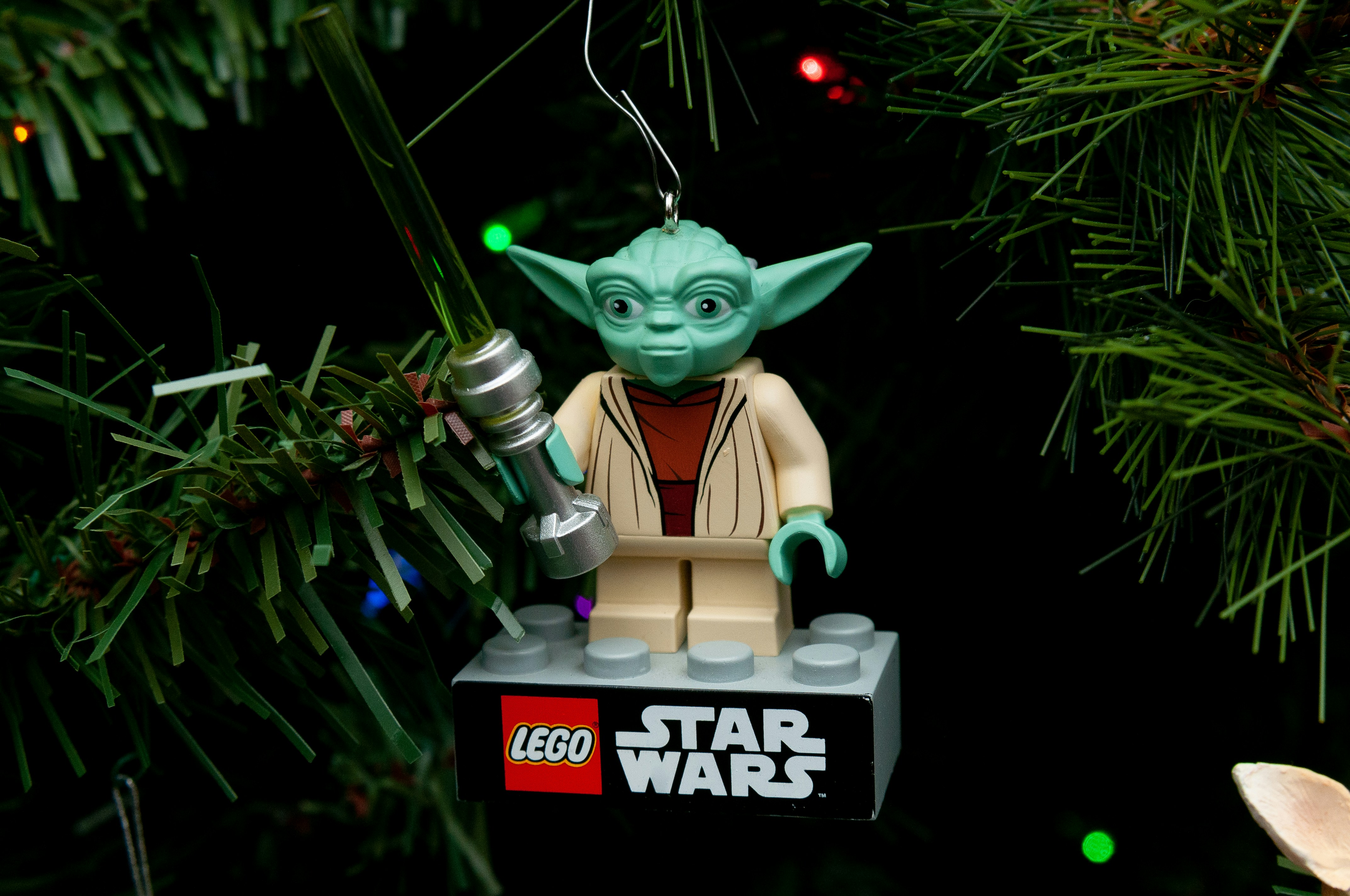 a lego star wars ornament hanging from a christmas tree