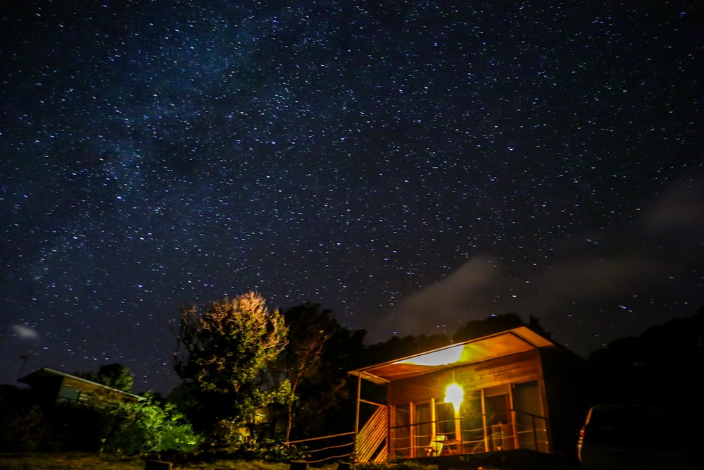 a cabin under a night sky with stars