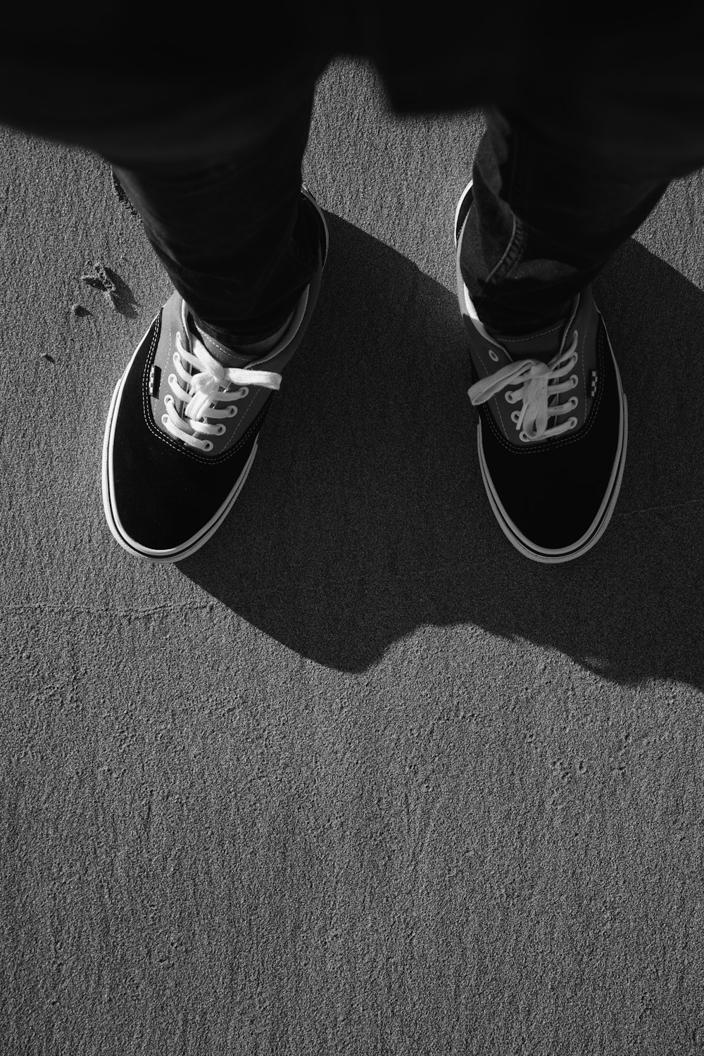 a black and white photo of a person's shoes