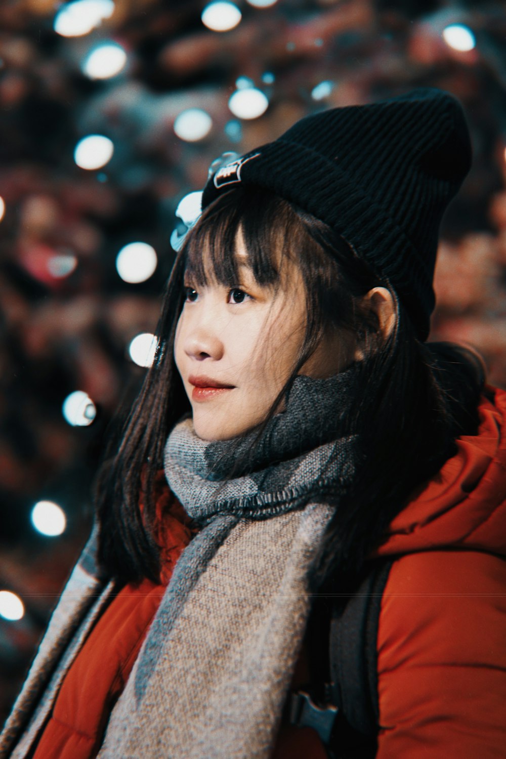 a woman in a red jacket and a black hat