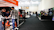 A trade show or exhibition hall with multiple booths lined along the aisles. People are interacting and exploring different displays. Some individuals are wearing masks. The hall is well-lit with banners and promotional materials displayed prominently.