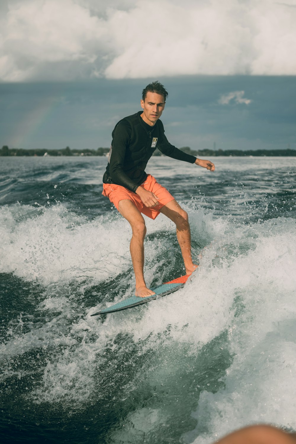 a man riding a wave on top of a surfboard