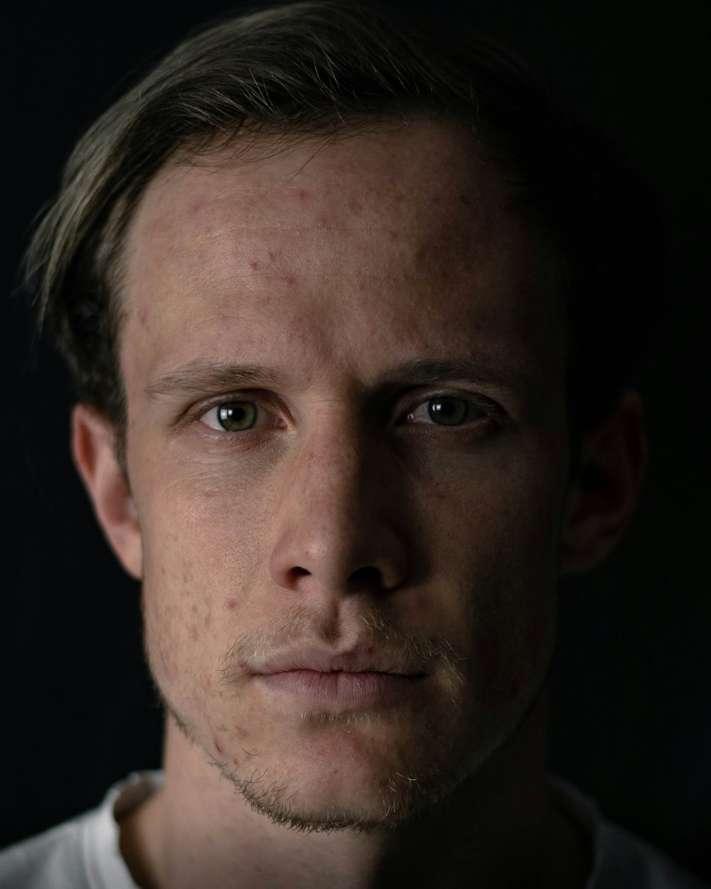 a close up of a person wearing a white shirt