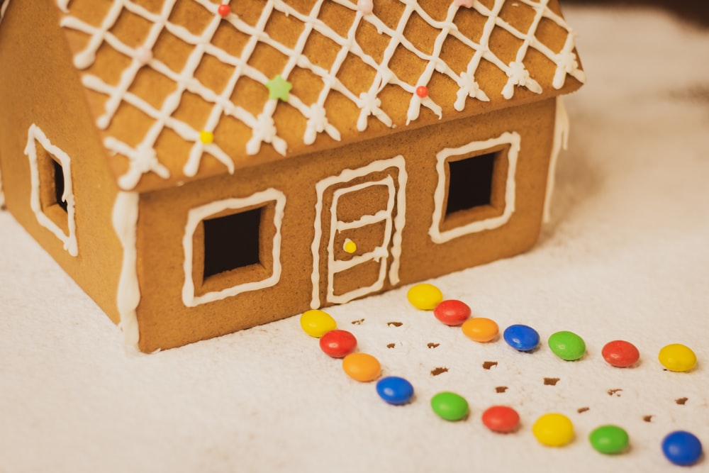 a gingerbread house with a lot of candy on the floor