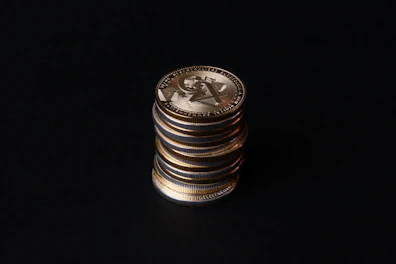Close-up of game currency icons glowing with golden light on dark background