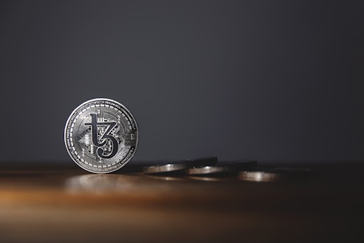 Close-up of a gleaming silver coin resting on a textured financial chart.