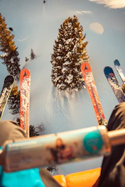 a person sitting in a chair with skis on their feet