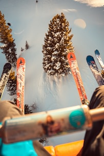 a person sitting in a chair with skis on their feet