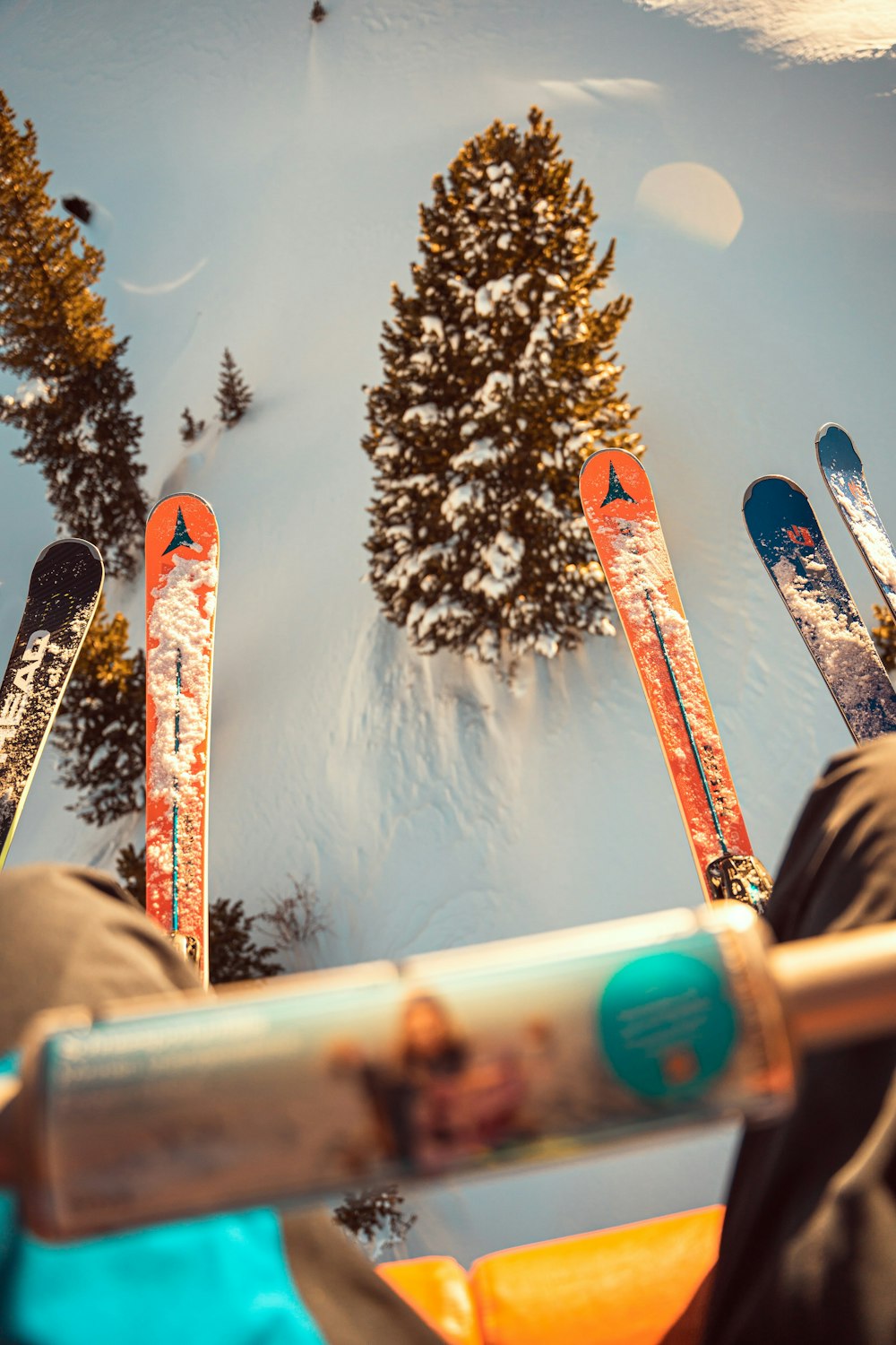 a person sitting in a chair with skis on their feet