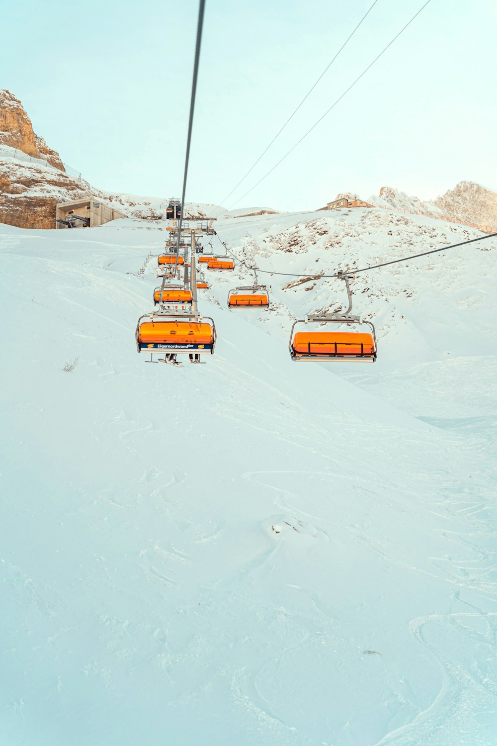 a ski lift going up a snowy mountain