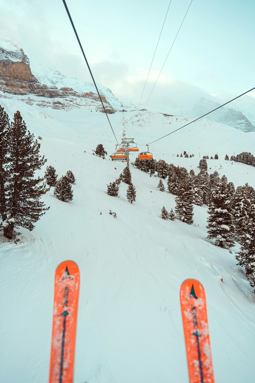 a ski lift going up a snowy mountain