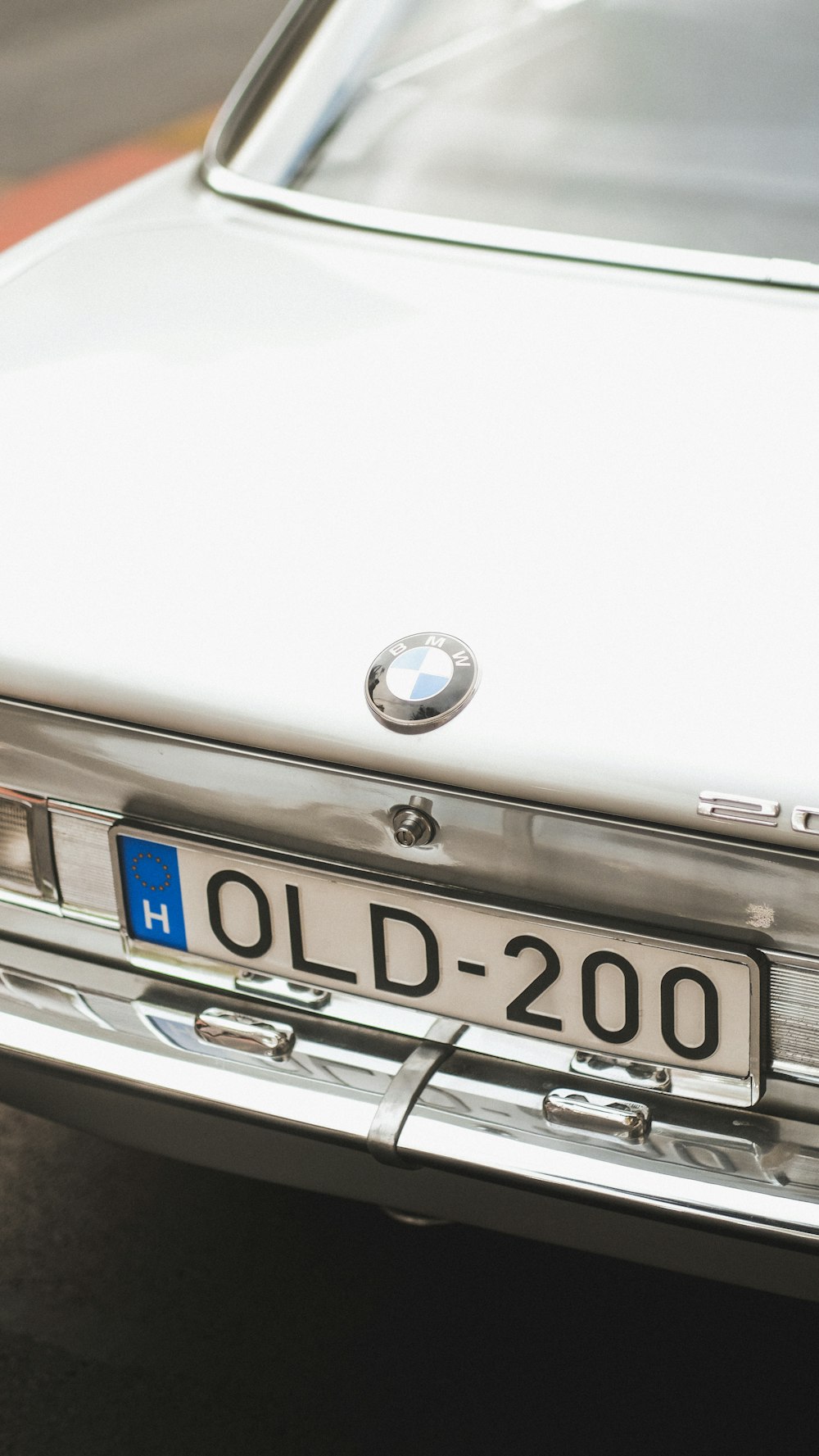 a close up of a white car with a license plate