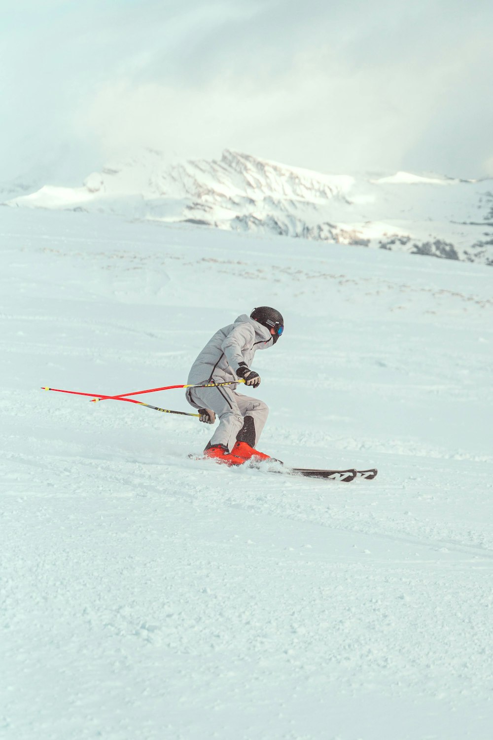 a man riding skis down a snow covered slope