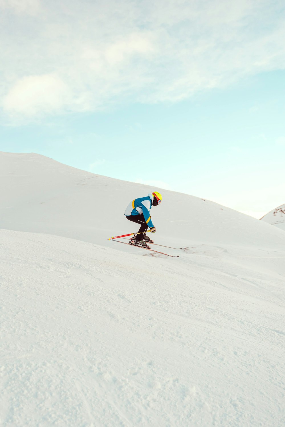 a man riding skis down a snow covered slope