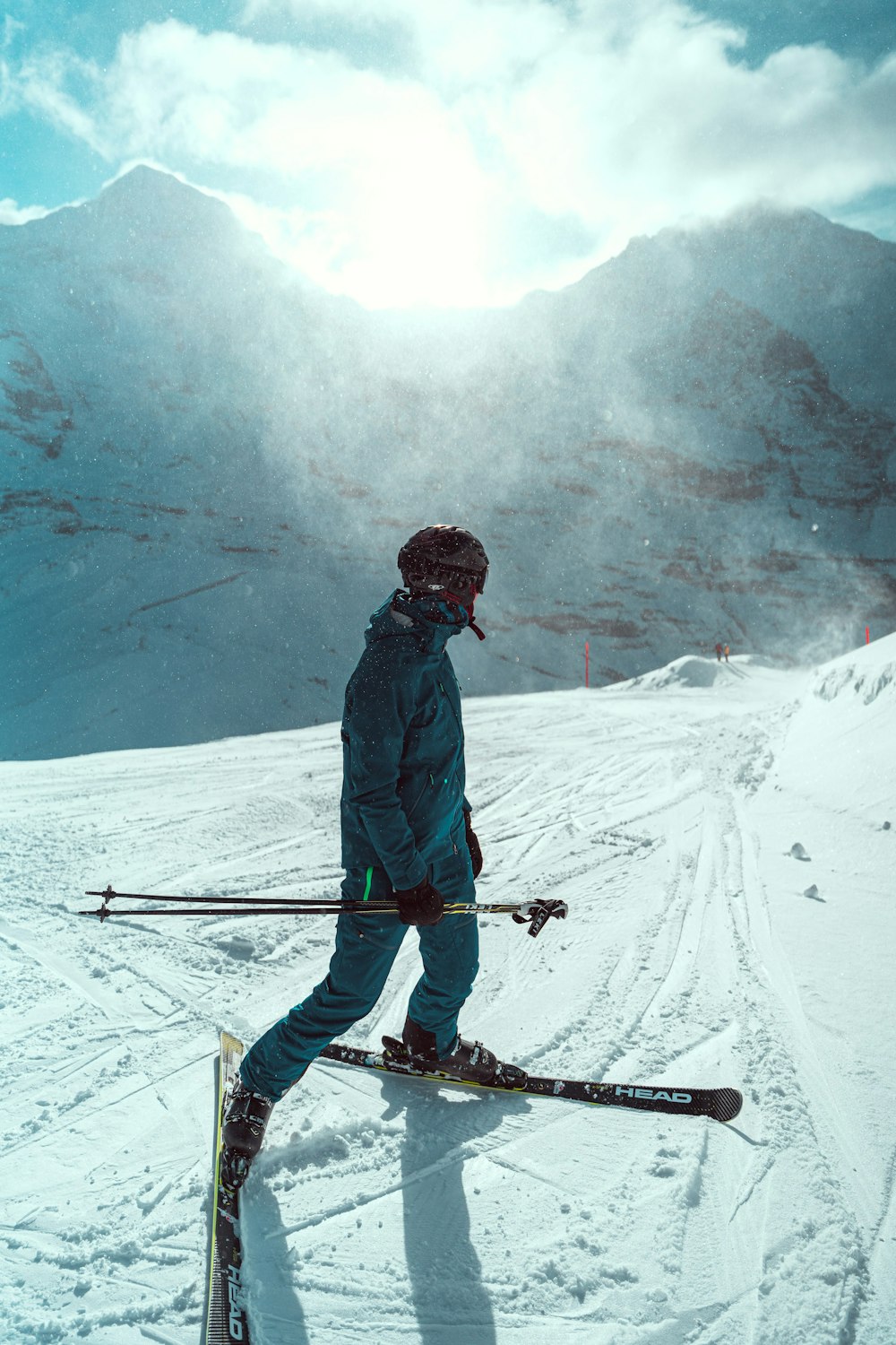 a man riding skis down a snow covered slope