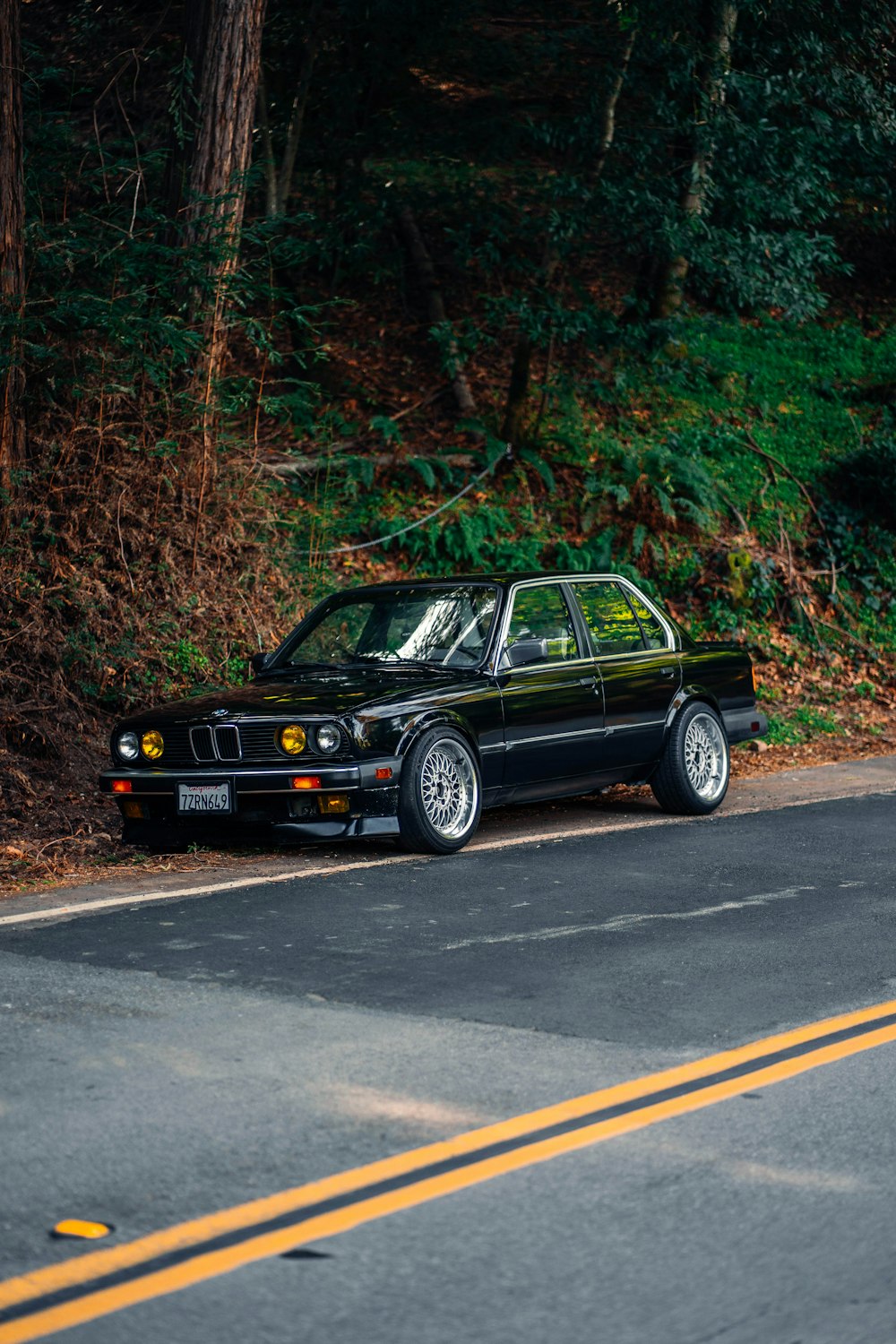 a black car parked on the side of the road