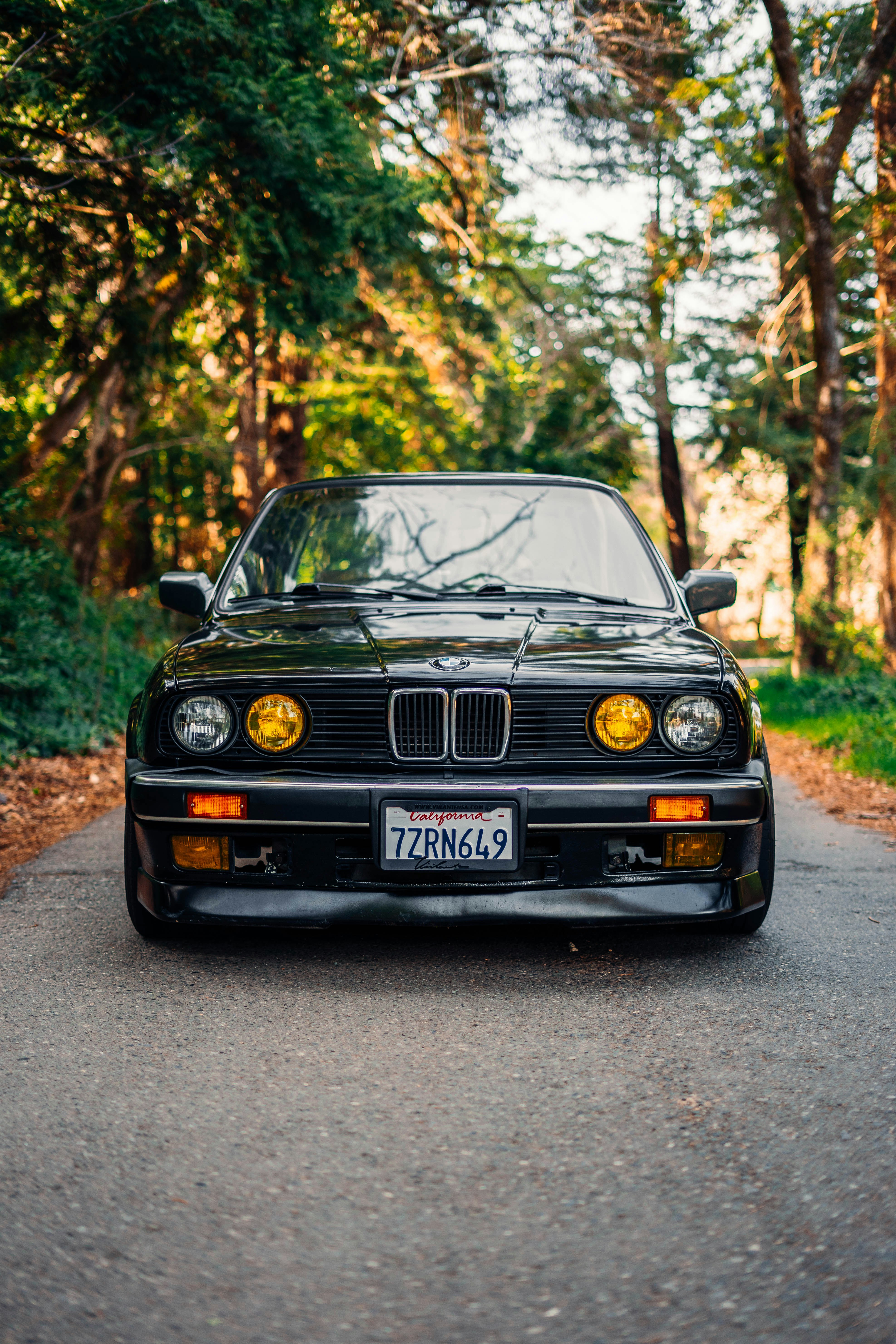 a black car parked on the side of a road