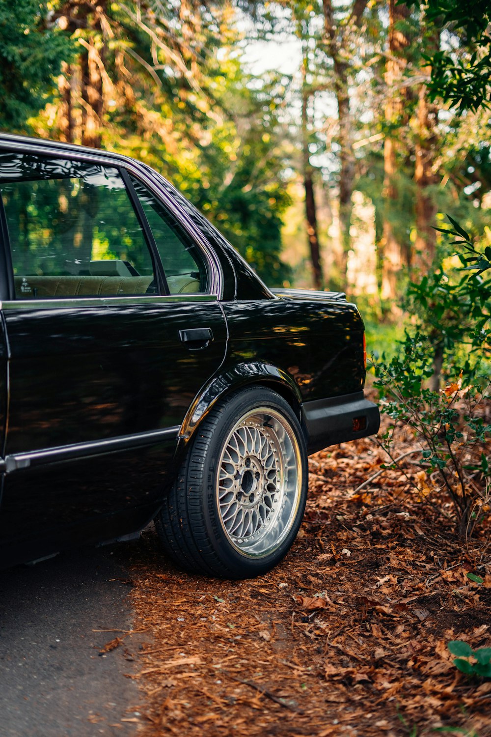 a black car parked on the side of the road