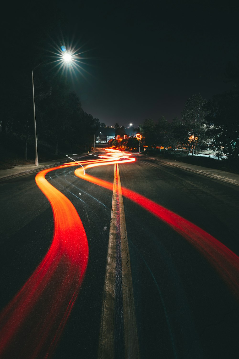 a long exposure photo of a street at night