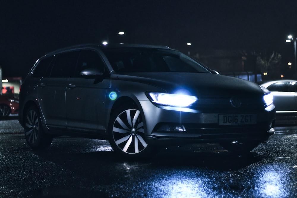 a car parked in a parking lot at night