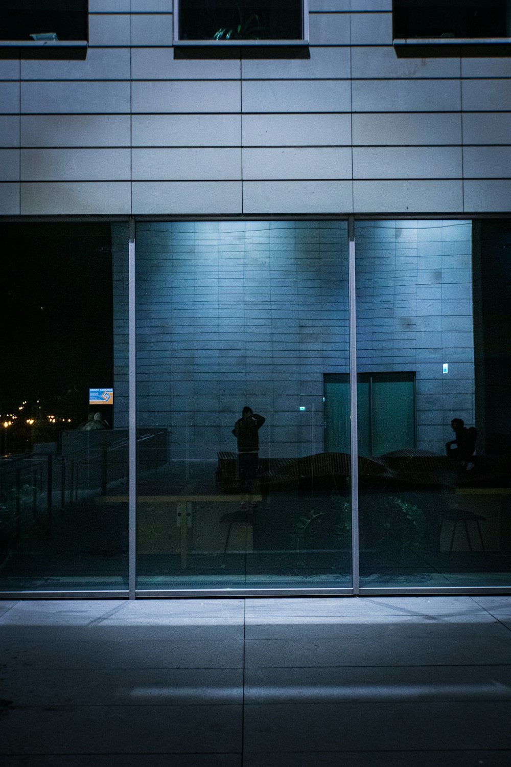 a person standing outside of a building at night