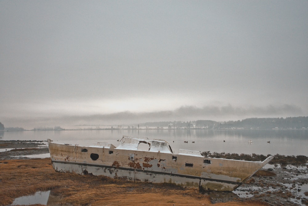 a boat sitting on top of a dry grass field