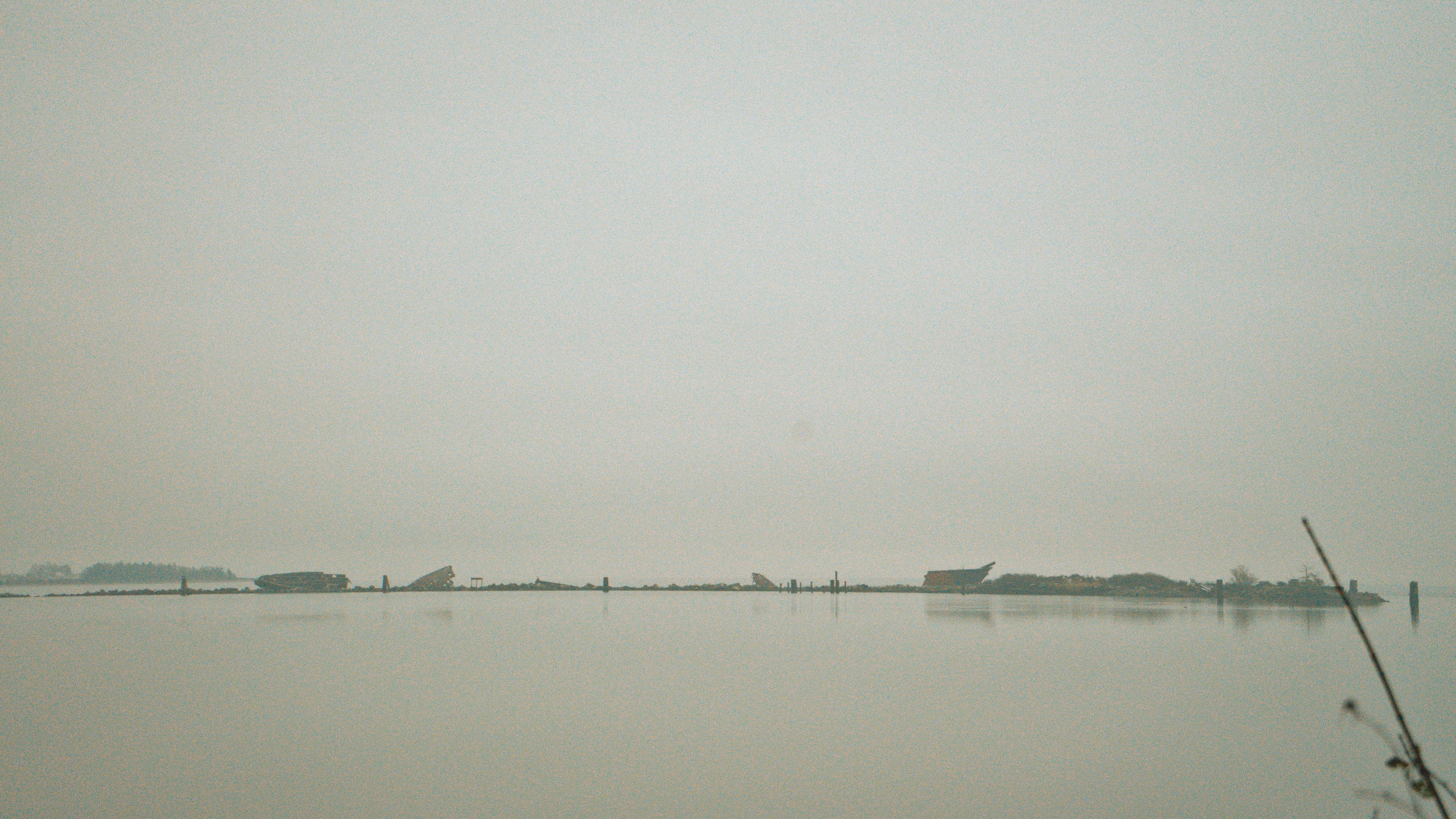 a large body of water with a boat in the distance, 