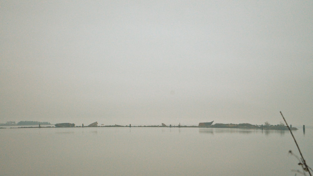 a large body of water with a boat in the distance