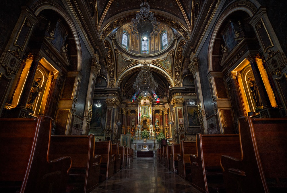 the inside of a church with pews and stained glass windows