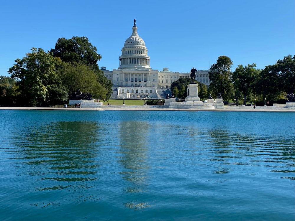 the capitol building is reflected in the water